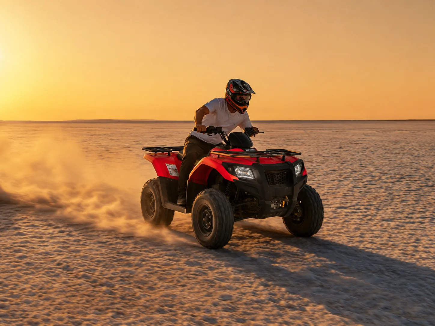 ATV all-terrain quad bike riding across the White Rann salt flats at Rann Utsav golden hour, Kutch